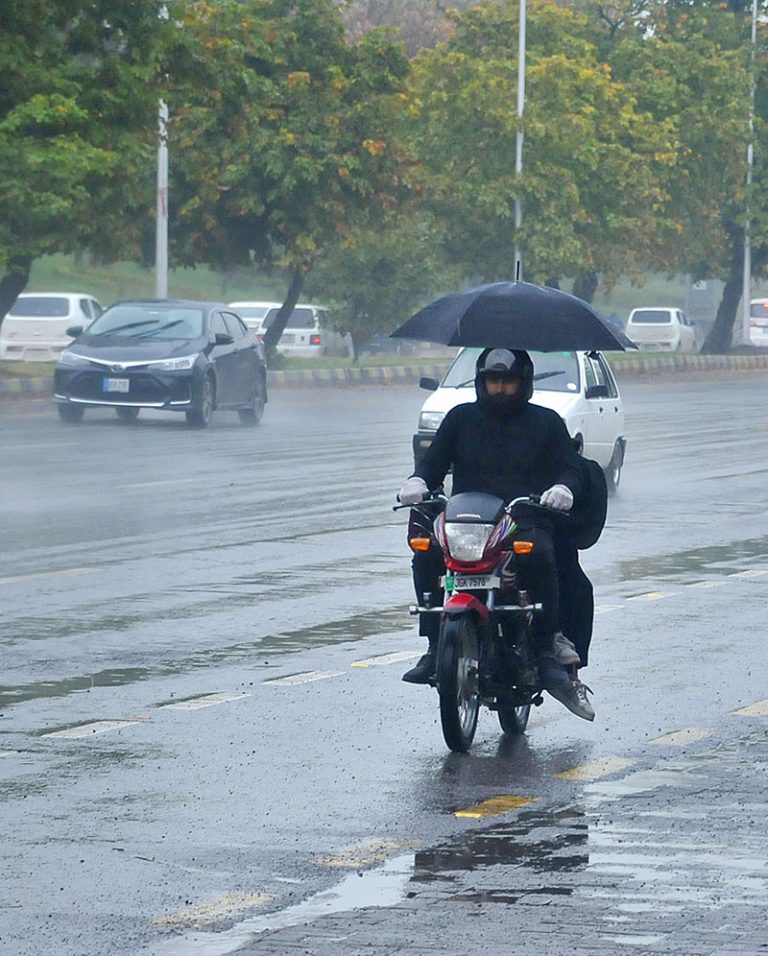 Commuters Are Wading Through Heavy Rain At Islamabad Expressway