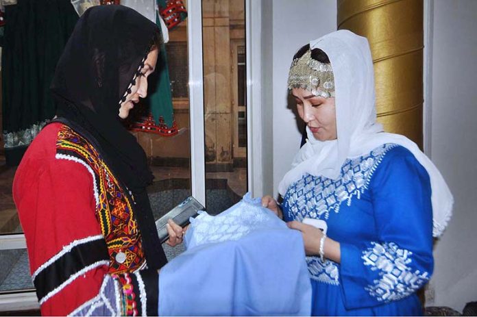 A Visitor Taking Interest In A Traditional Hazaragi Costume Displayed