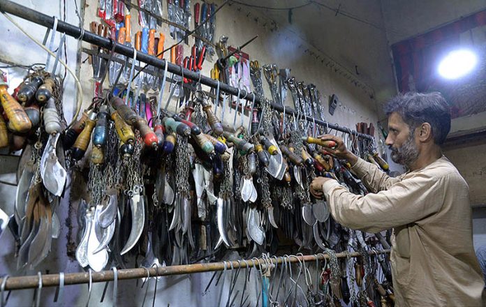 A Blacksmith Busy In Sharpening The Knives To Be Used By Mourners