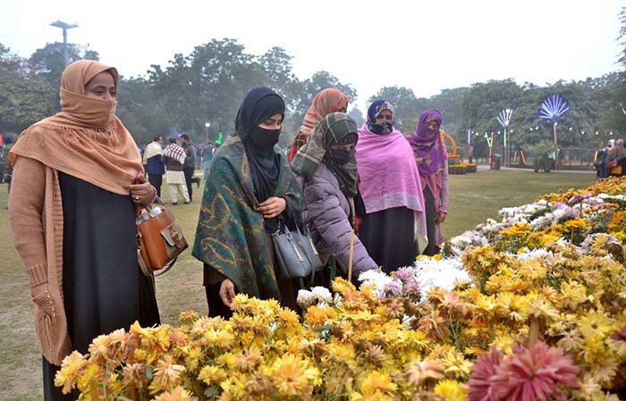 Visitor Taking A Keen Interest In Flowers During The Annual Gul Dawoodi