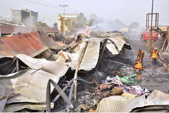 Firefighters busy in operation to extinguish fire after yesterday’s fire erupts in weekly bazaar at H-9 Peshawar Morr