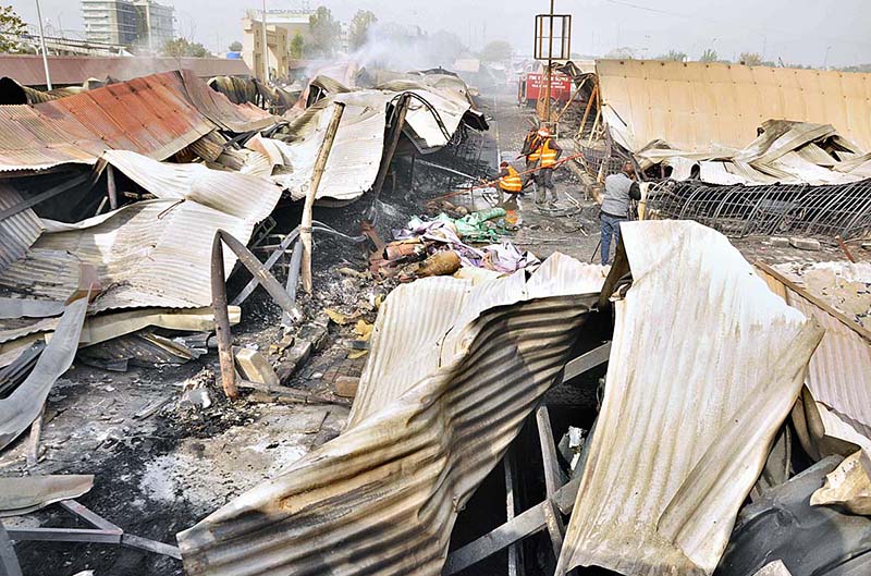 Firefighters busy in operation to extinguish fire after yesterday’s fire erupts in weekly bazaar at H-9 Peshawar Morr