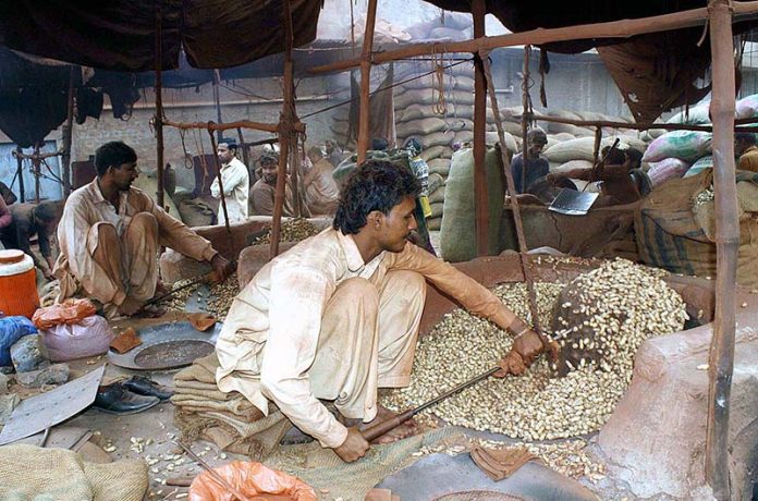 Workers roasting peanuts at Grain Market