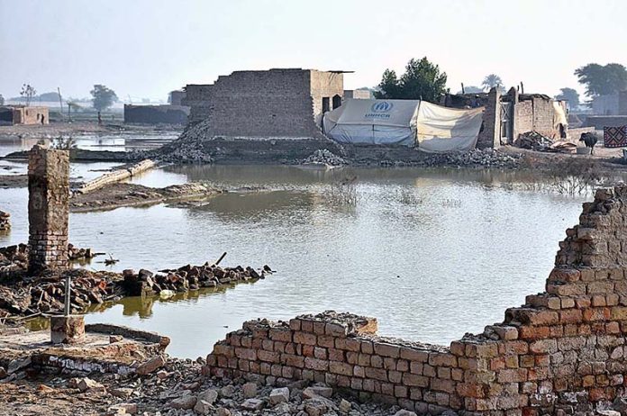 A view of submerged houses after four months of flash flood water as millions of houses and roads damaged and washed away due to deadly flood hit the area of Areeja Fariha Village Road near bypass.