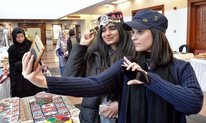 Girls capturing moments during closing ceremony of 12th Pakistan Mountain Festival organized by Devcom-Pakistan and Pakistan National Council of the Arts