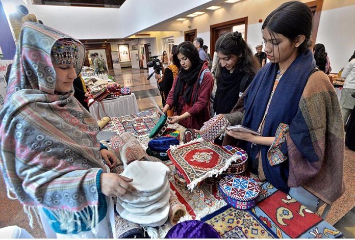 Girls visiting stalls during closing ceremony of 12th Pakistan Mountain Festival organized by Devcom-Pakistan and Pakistan National Council of the Arts