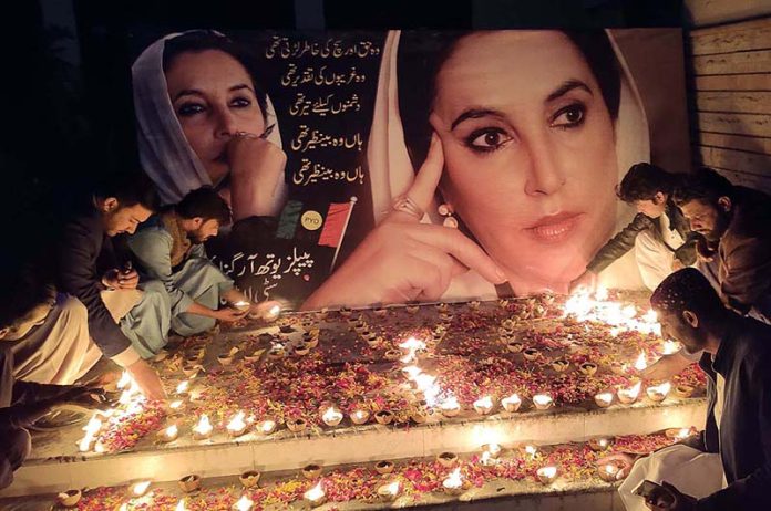 Workers of Pakistan Peoples Party lights candles to pay tribute to Former Prime Minister Shaheed Mohtarma Benazir Bhutto on the occasion of her 15th death anniversary in front of Press Club.