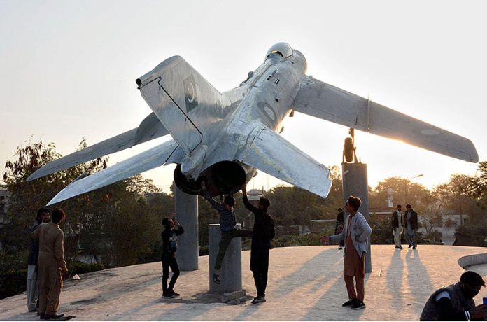 Youngsters enjoying and looking at model of fighter jet installed at Pahari Ground