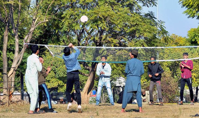 Youngsters playing volleyball at local park in G7 area