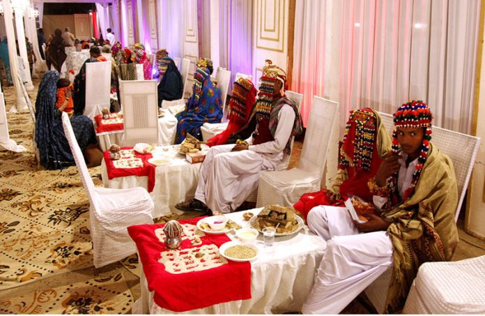 Brides and grooms sit together during a mass marriage ceremony held in Railway ground, A total of 65 couples from the Hindu community across Pakistan took their wedding vows during the mass wedding ceremony organized by the Pakistan Hindu Council