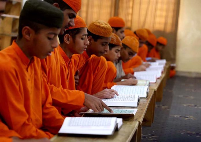 Madrassa students reading Holy Quran at Dars-e-Noor Madrasa (Islamic seminary) during the holy month of Ramzan