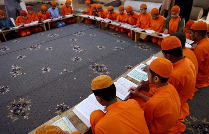 Madrassa students reading Holy Quran at Dars-e-Noor Madrasa (Islamic seminary) during the holy month of Ramzan