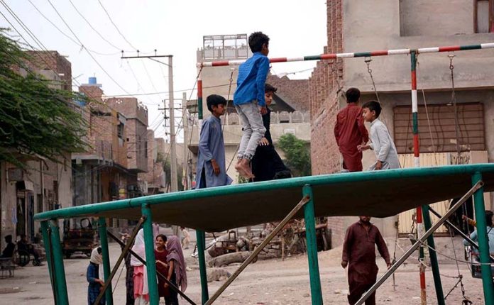 Children enjoys on jumping jack at road side setup