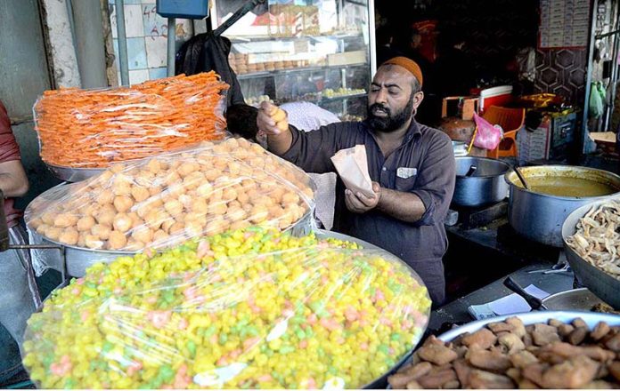 A vendor is selling sweets food items in connection with Shab-e-Barat at Gawalmandi