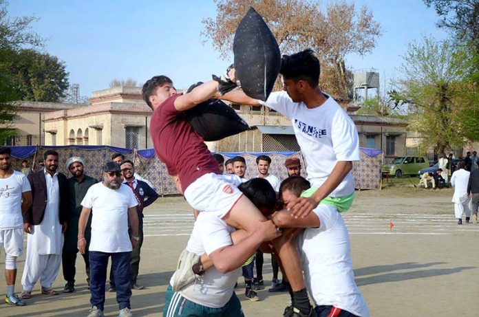 Students participating in the pillow fighting competition during the annual competitions of Government Graduate College Attock