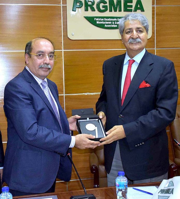 Leader of PRGMEA, Ejaz A Khokhar presenting A shield to Federal ...