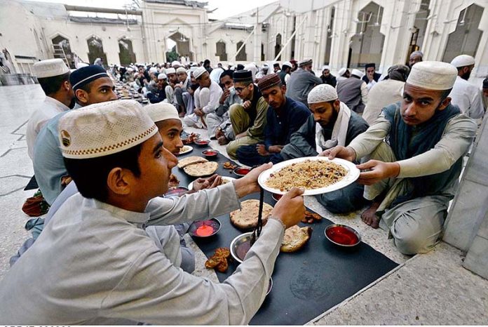 Faithful breaking fast at Dervish Masjid on the first of Ramazan