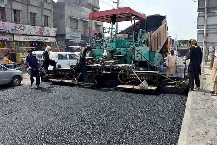 Workers working on Kashmir Road during development project in the city