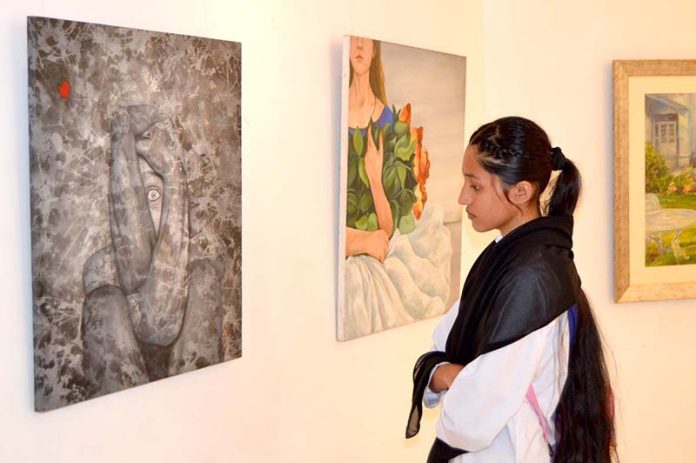 A girl visitor visiting Al Hamra Art Gallery on occasion of ...