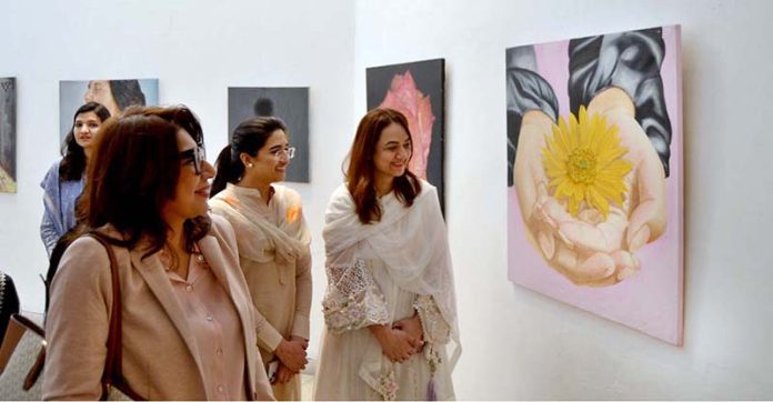 A girl visitor visiting Al Hamra Art Gallery on occasion of ...