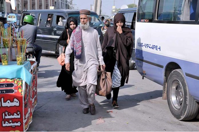 People come back to the city at Faizabad Bus Stand after spending Eid ul Fitr holidays in their hometowns