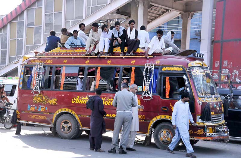 People come back to the city at Faizabad Bus Stand after spending Eid ul Fitr holidays in their hometowns