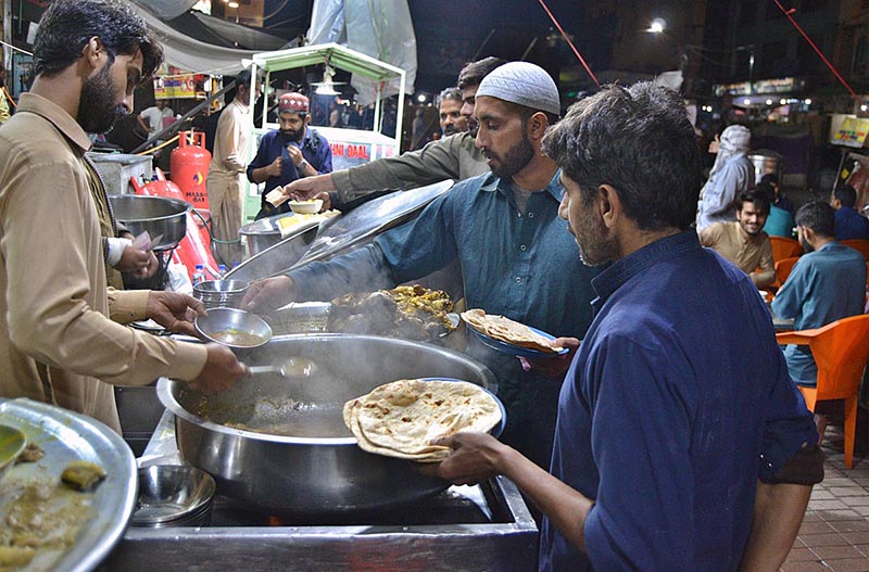 A Vendor Selling Traditional Food Stuff To Customers For Sehri At 