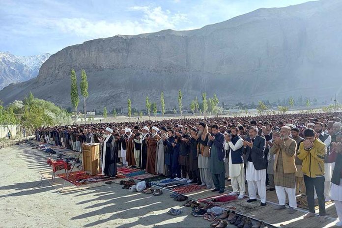 A large number of faithful offering Eid-ul-Fitr prayer at Eidgah Skardu