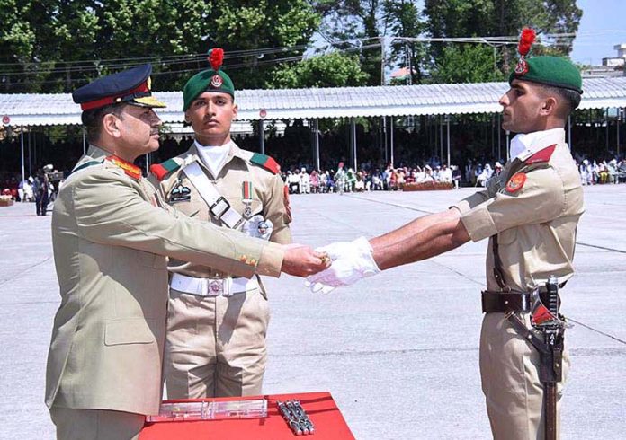 COAS, General Syed Asim Munir, gives cane to a cadet during 147th PMA Long Course, 13th Mujahid Course, 66th Integrated Course, 6th Basic Military Training Course and 21st Lady Cadet Course at Pakistan Military Academy (PMA)