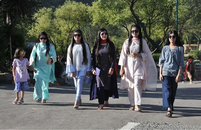 Women walk at the picnic point Daman e Koh during celebrate the 2nd day of Eid ul Fitr