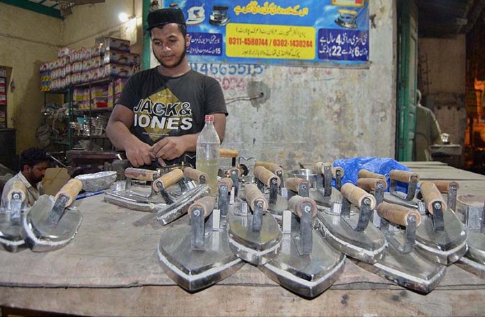 Electric Engineer making and repairing irons at his work place