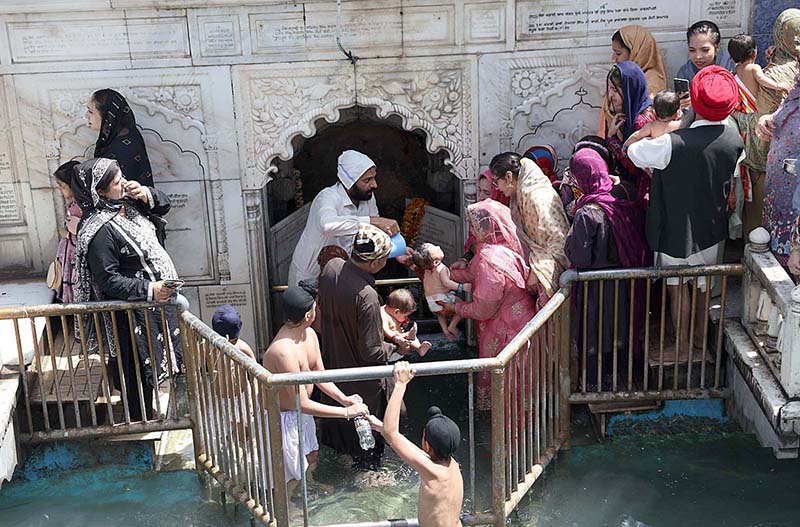 An elder Granthi waving the chauri ( Horse hair fan) over the Guru Granth Sahib during the annual Baisakhi harvest festival, with the main ceremony of the New Year's celebration of Sikh community at their Holy Shrine Panja Sahib in Hasan Abdal.