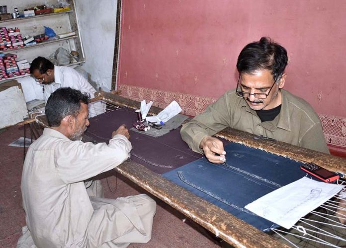 Artisans are making zardozi embroidery by hand at a workshop ahead of Eid-ul-Fitar during the Holy Month of Ramadan-ul- Mubarak.