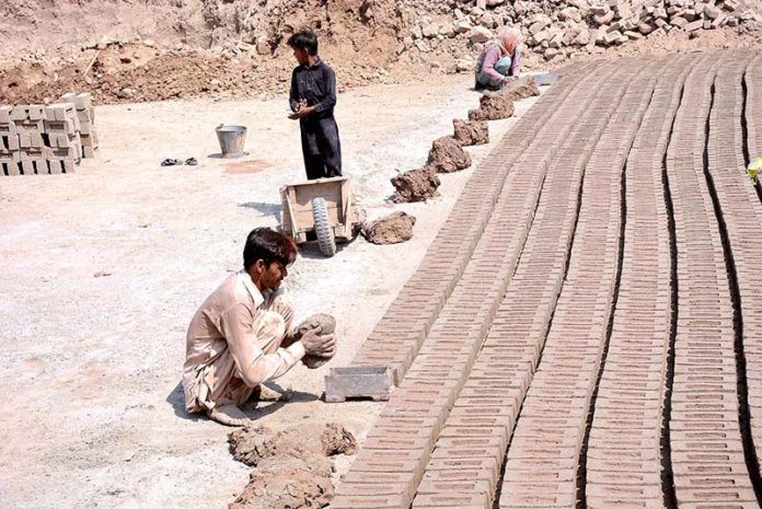 Labourers preparing bricks at a Local Bricks Kiln