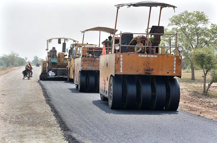 Heavy machinery being used during road construction work at Jhumra road bypass to Millat Road