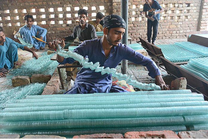 Labourers preparing the bangles in the local bangles factory at Site Area