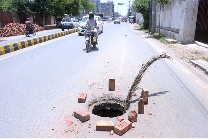 A view of an open manhole at High court road needs the attention of ...