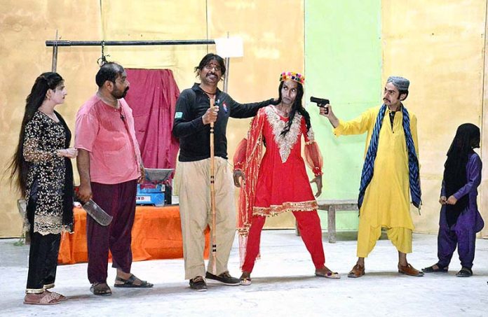 Artists performing on stage in drama 