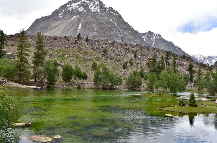 A scenic view of Satrangi Lake Nalter valley attracting visitors in the mountain area of Gilgit-Baltistan