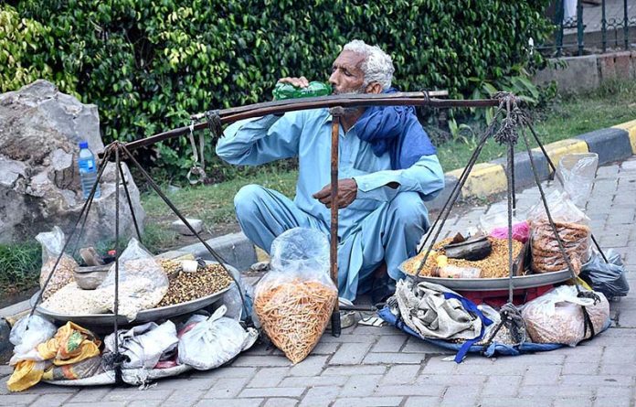 A labourer is waiting for customers as the world marks International Labour Day