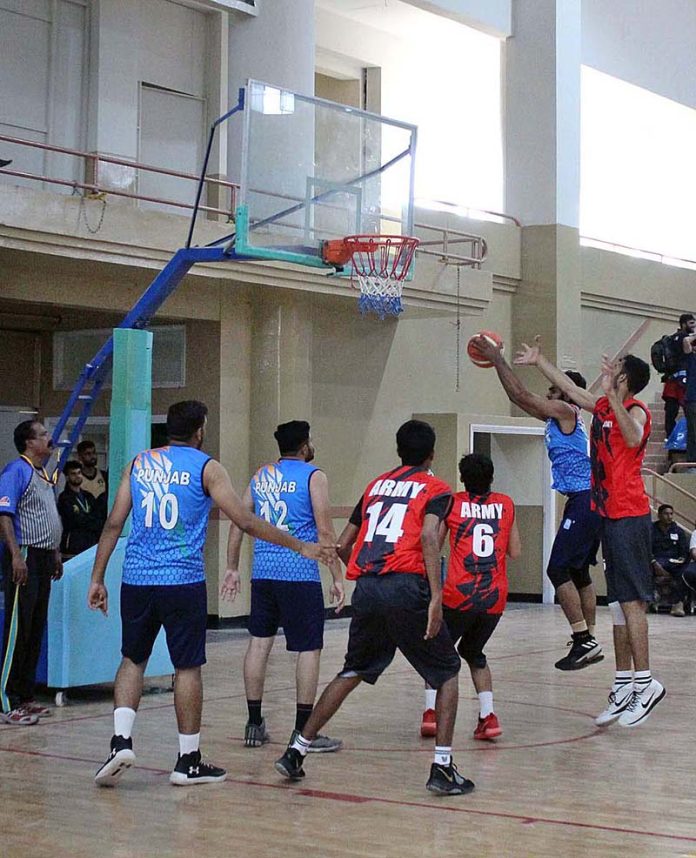 Players in action during a match of basketball between Pakistan Army and Punjab teams under 34th National Games