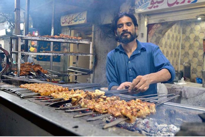 A vendor is preparing barbeque to the customers in Food Street Gawalmandi