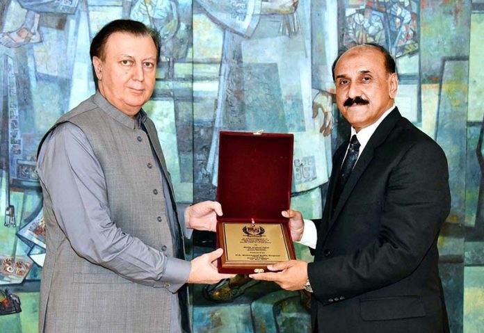 Secretary Senate, Mohammad Qasim Samad Khan presenting a shield to Malik Arshad Iqbal, Joint Secretary Senate on his retirement from Senate Secretariat at Parliament House