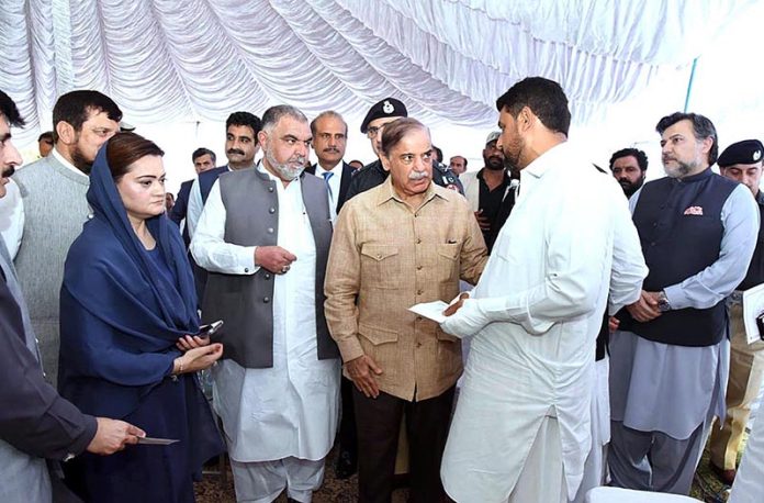 Prime Minister Muhammad Shehbaz Sharif distributes cheques among the employees of Radio Pakistan Peshawar who got injured during attack on Radio Pakistan