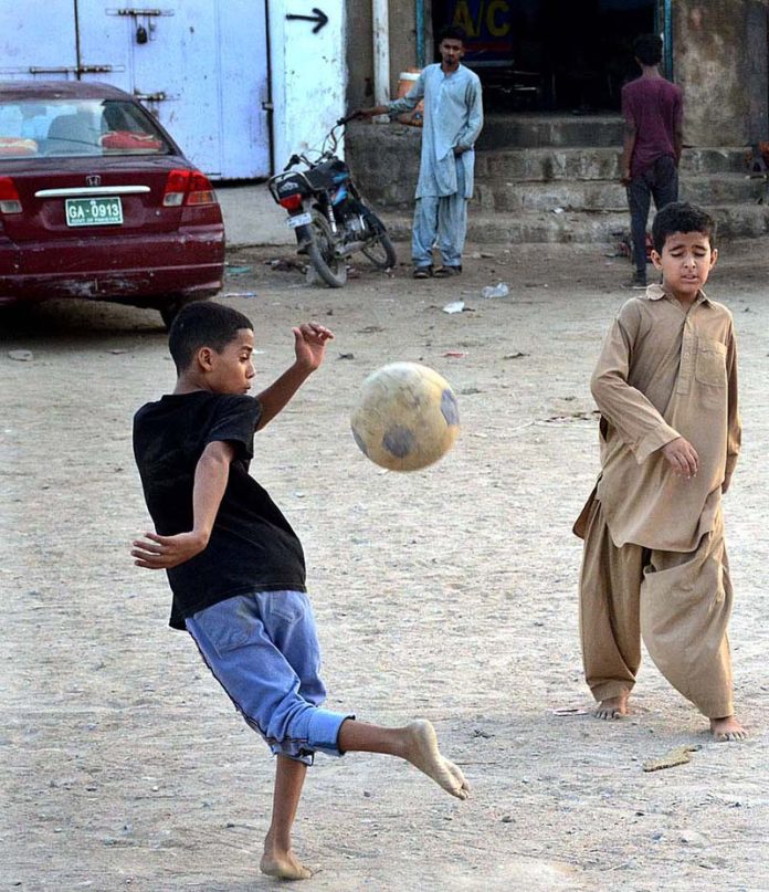 Children playing football in Mehmoodabad area