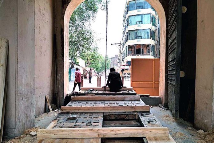 The workers engaged in the restoration work of the historic Shahi Fort’s Roshnai Gate