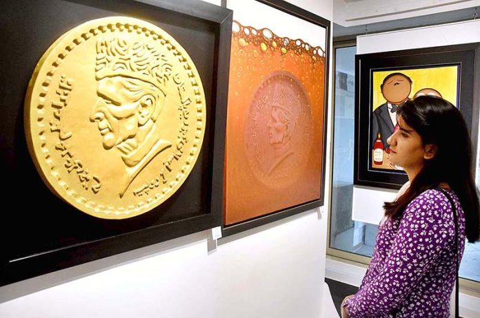 A visitor viewing the painting during Painting and Sculptures Exhibition (Conceptual Reality “Bridging Thoughts on Canvas”) at Revivers Galleria