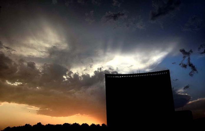 An eye catching view of dark clouds hovering in the golden sky after thunder storm in the city