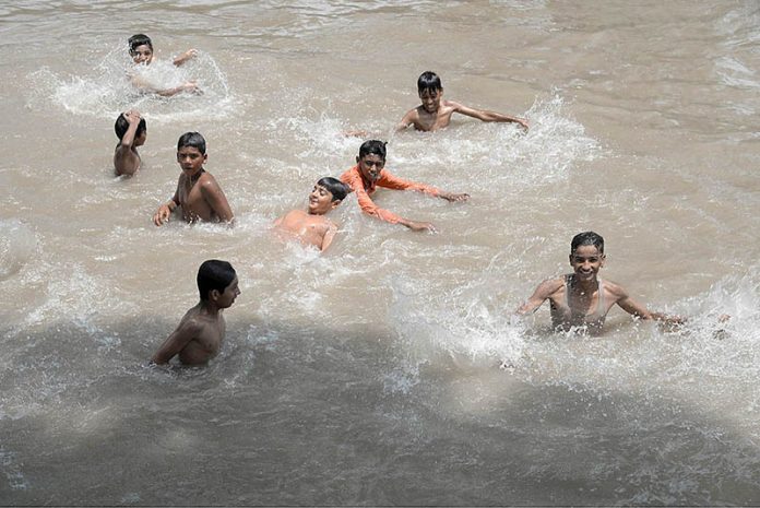 Youngsters enjoying in the canal to get relief from the hot weather