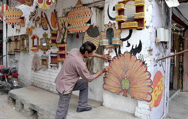 A man is preparing traditional tooth bursh (Miswak) at Qila Gujjar Singh Area